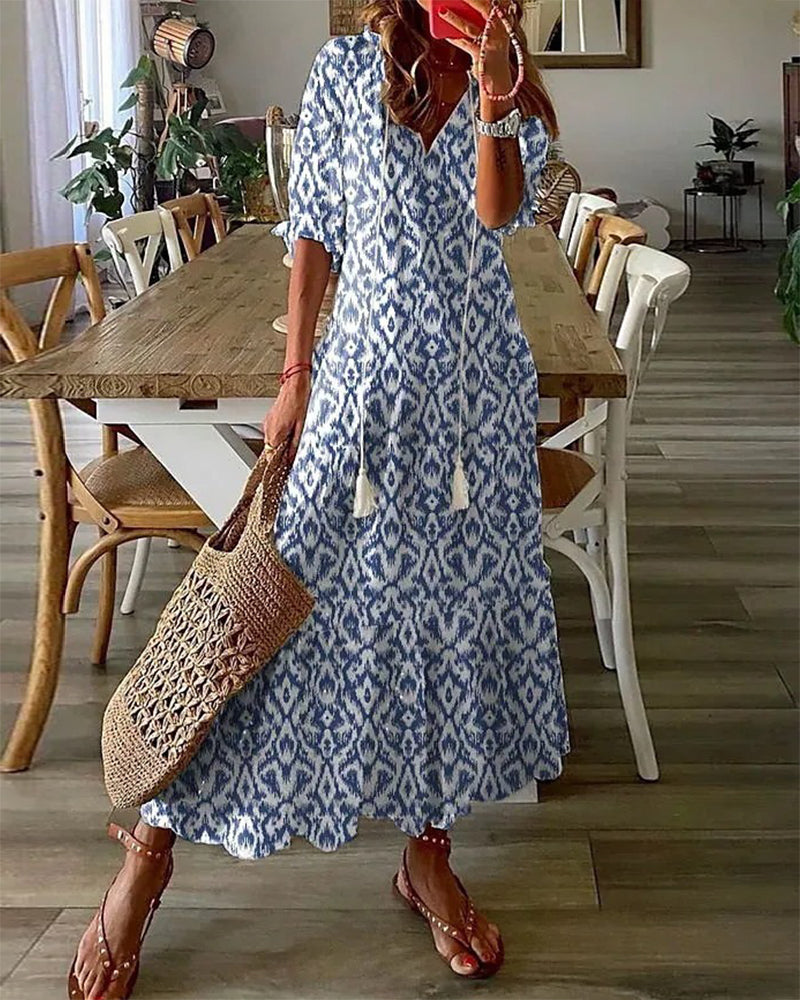 Boho midi dress in blue with navy geometric pattern, short sleeves and tiered hem
