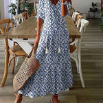 Boho midi dress in blue with navy geometric pattern, short sleeves and tiered hem