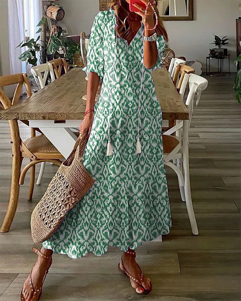 Boho midi dress in green with white geometric pattern, short sleeves and tiered hem