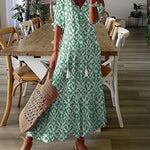 Boho midi dress in green with white geometric pattern, short sleeves and tiered hem