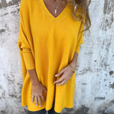 Mustard yellow V-neck pullover sweater with three-quarter sleeves and soft drape.