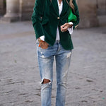 Green velvet blazer with notch lapels, gold button front, long sleeves, flap pockets