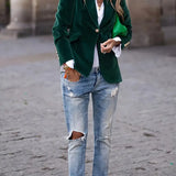 Green velvet blazer with notch lapels, gold button front, long sleeves, flap pockets