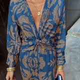 Blue patterned V-neck midi dress with knotted front and long sleeves