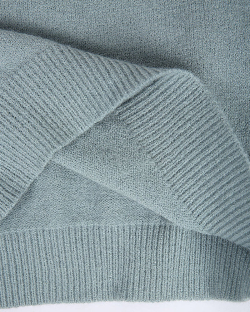 Light blue ribbed knit fabric detail on a fair isle pullover sleeve