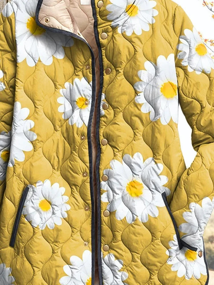 Yellow quilted women’s jacket with large white daisies, button placket and dark trim