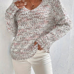 Loose knit pullover sweater with long sleeves, red-and-white speckled knit front