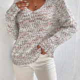 Loose knit pullover sweater with long sleeves, red-and-white speckled knit front