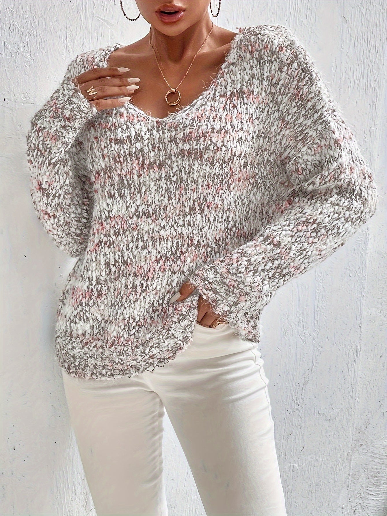 Loose knit pullover sweater with long sleeves, red-and-white speckled knit front