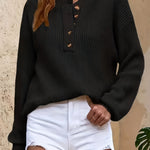 Black knit pullover henley sweater with button-front placket and ribbed cuffs