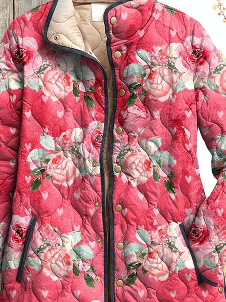 Women's pink floral print quilted jacket close-up with button placket and stand collar