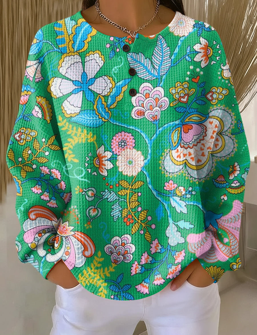 Green pullover with colorful ethnic floral pattern and four-button placket