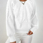 White cable-knit long-sleeve pullover with half-zip neckline and ribbed cuffs