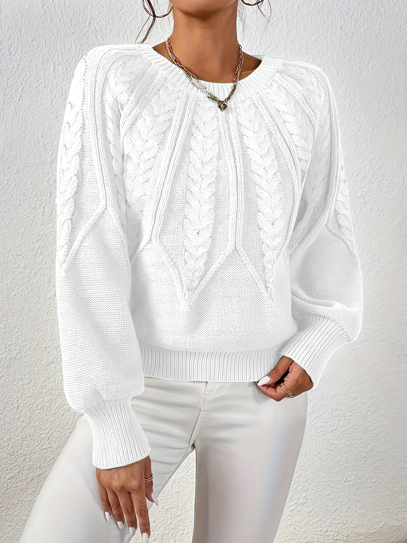 White cable-knit long-sleeve pullover with half-zip neckline and ribbed cuffs