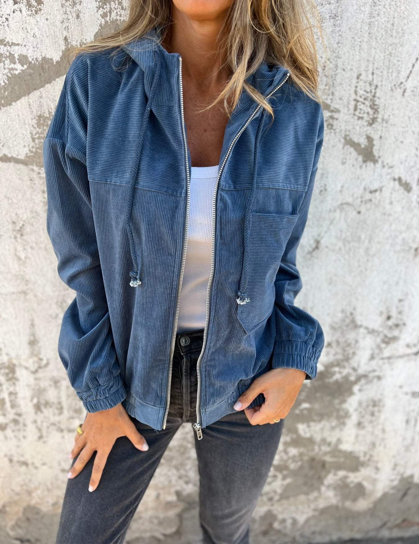 Blue hooded zip-up utility jacket with drawstring hem and front pockets