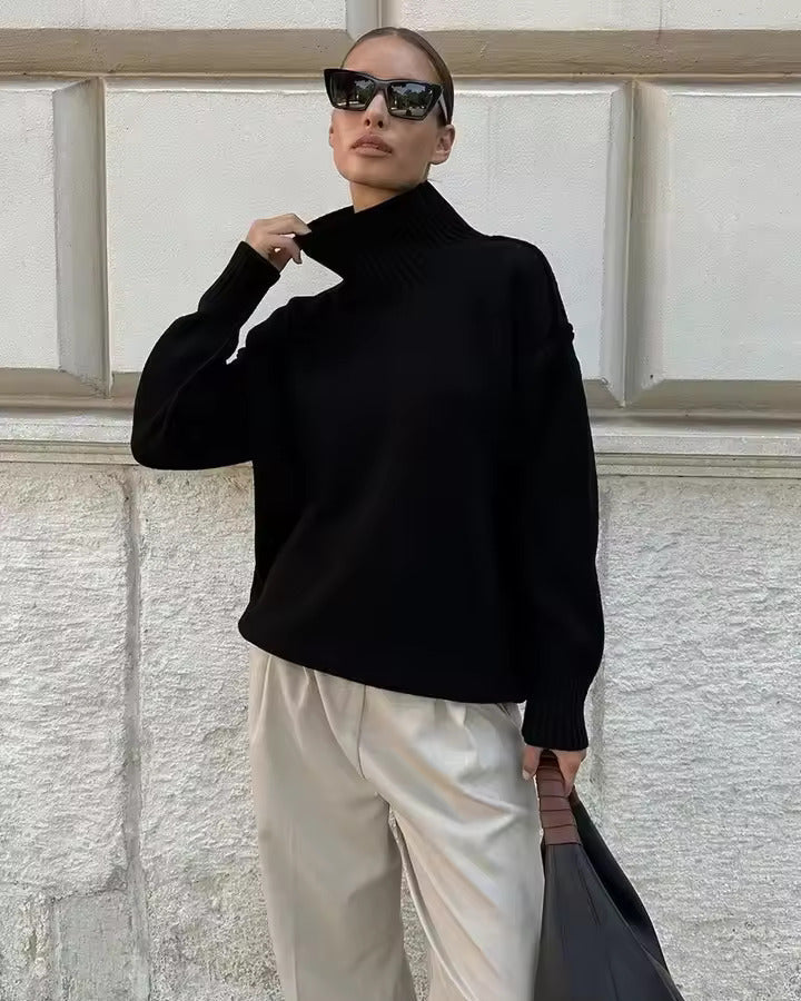 Black knit turtleneck sweater with ribbed cuffs and loose fit