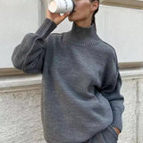 Gray knit turtleneck sweater with long sleeves and ribbed roll collar