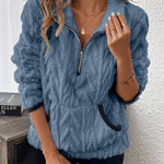 Blue fuzzy quarter-zip pullover with short sleeves and navy-trim accents