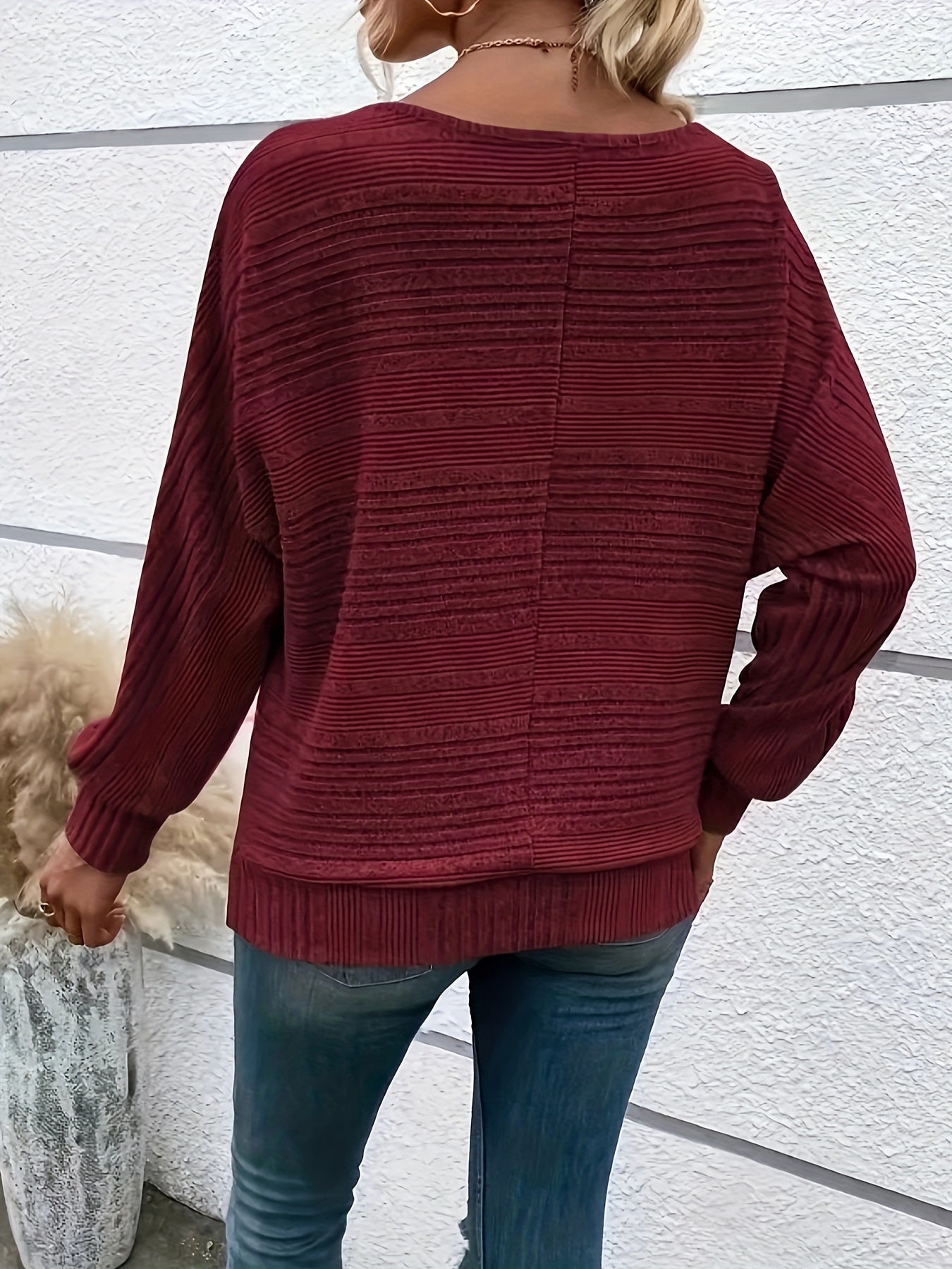Burgundy striped knit pullover with batwing sleeves, ribbed cuffs and hem