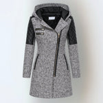 Women’s winter parka coat in light gray with black quilted sleeves, zip front, hood.