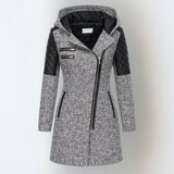 Women’s winter parka coat in light gray with black quilted sleeves, zip front, hood.
