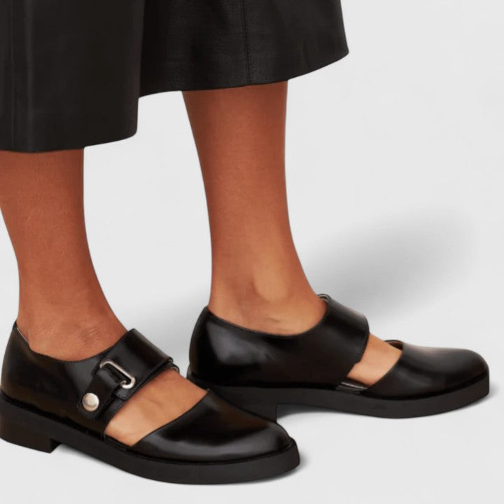 Black orthopedic Mary Janes with adjustable buckle strap and rounded toe