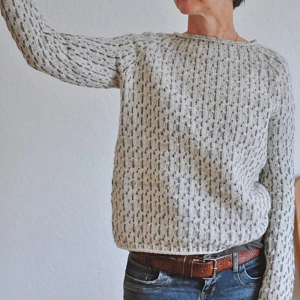 Speckled knit sweater with ribbed crew neck, long sleeves, and relaxed fit