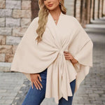 Cream draped poncho with V-neck and gathered front knot, wide cape sleeves