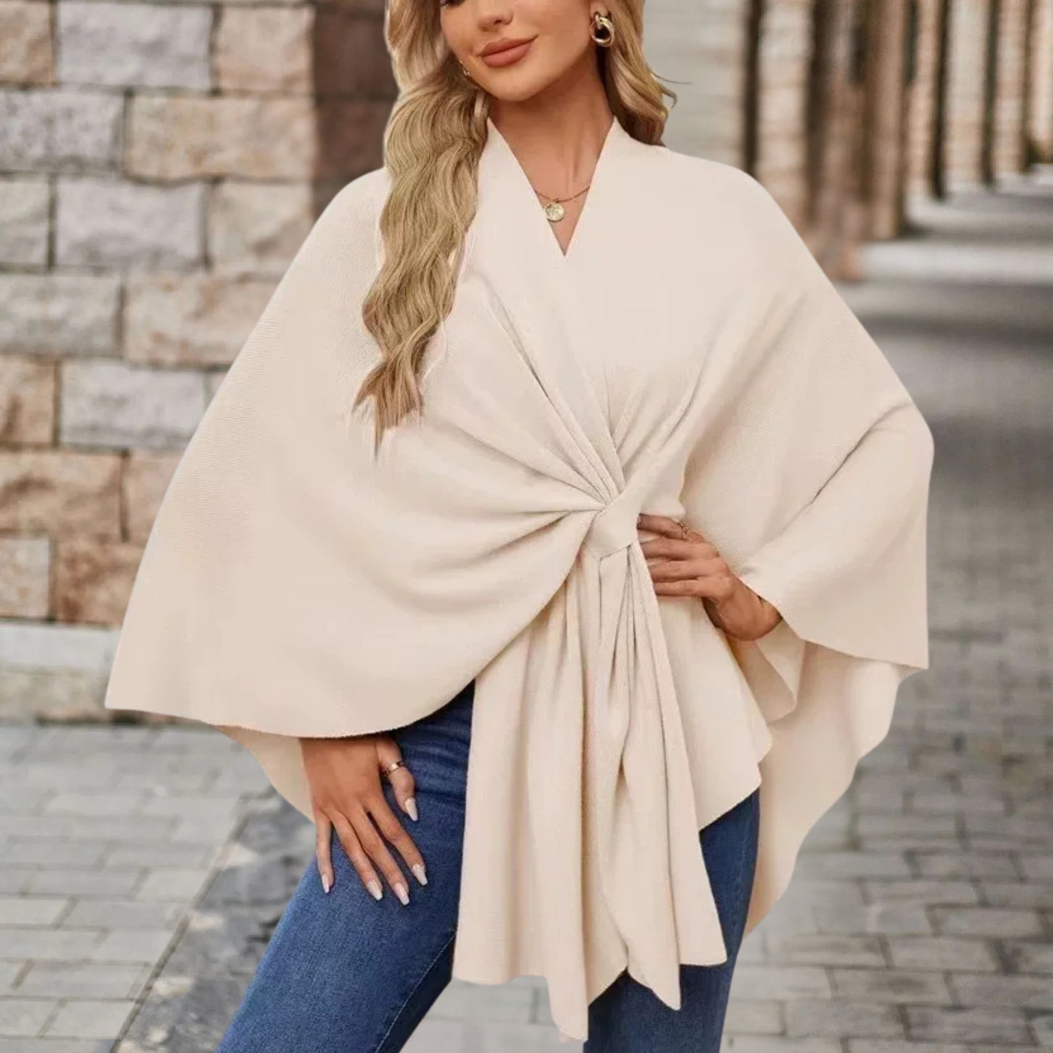 Cream draped poncho with V-neck and gathered front knot, wide cape sleeves