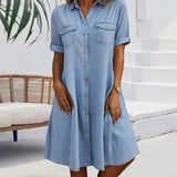 Light blue denim shirt dress with short sleeves, button front, and chest pockets