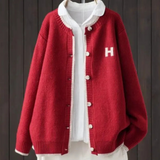 Red classic cardigan with button front, ribbed trim, and 'H' patch