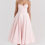 Blush pink fitted corset-style slimming dress with spaghetti straps and full midi skirt