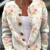Cream knit button cardigan with pink floral print and green leaf details, V-neck
