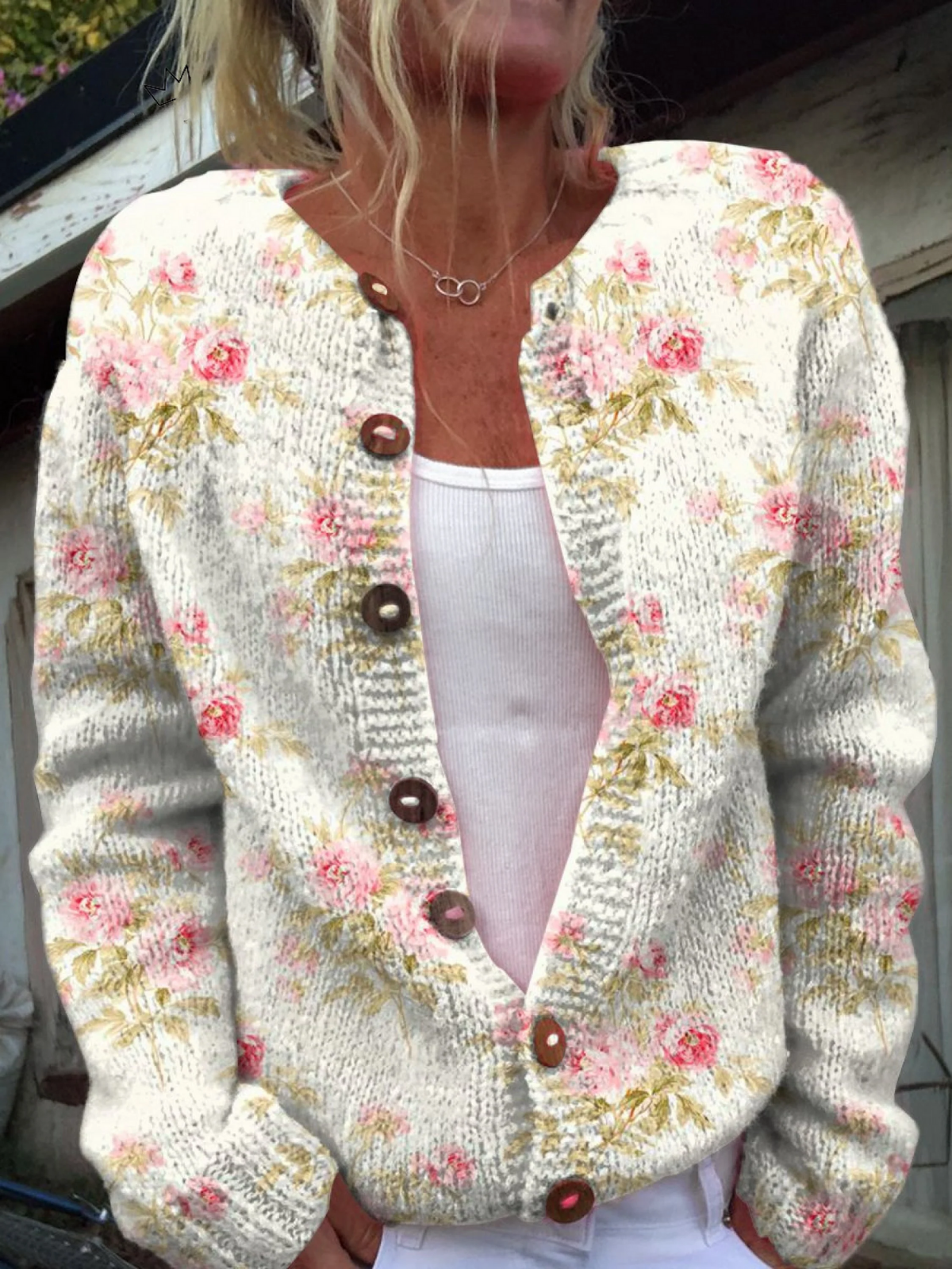 Cream knit button cardigan with pink floral print and green leaf details, V-neck