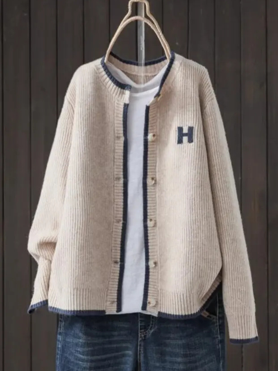 Light beige classic cardigan with button front, ribbed trim, and 'H' patch