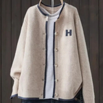 Light beige classic cardigan with button front, ribbed trim, and 'H' patch