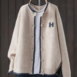 Light beige classic cardigan with button front, ribbed trim, and 'H' patch