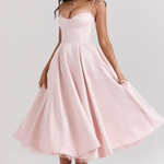 Blush pink sleeveless corset dress with thin straps and swingy flared midi skirt