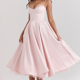 Blush pink sleeveless corset dress with thin straps and swingy flared midi skirt