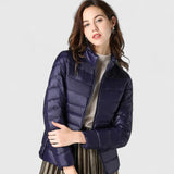 Elegant quilted zip-up puffer jacket in navy with stand collar and long sleeves