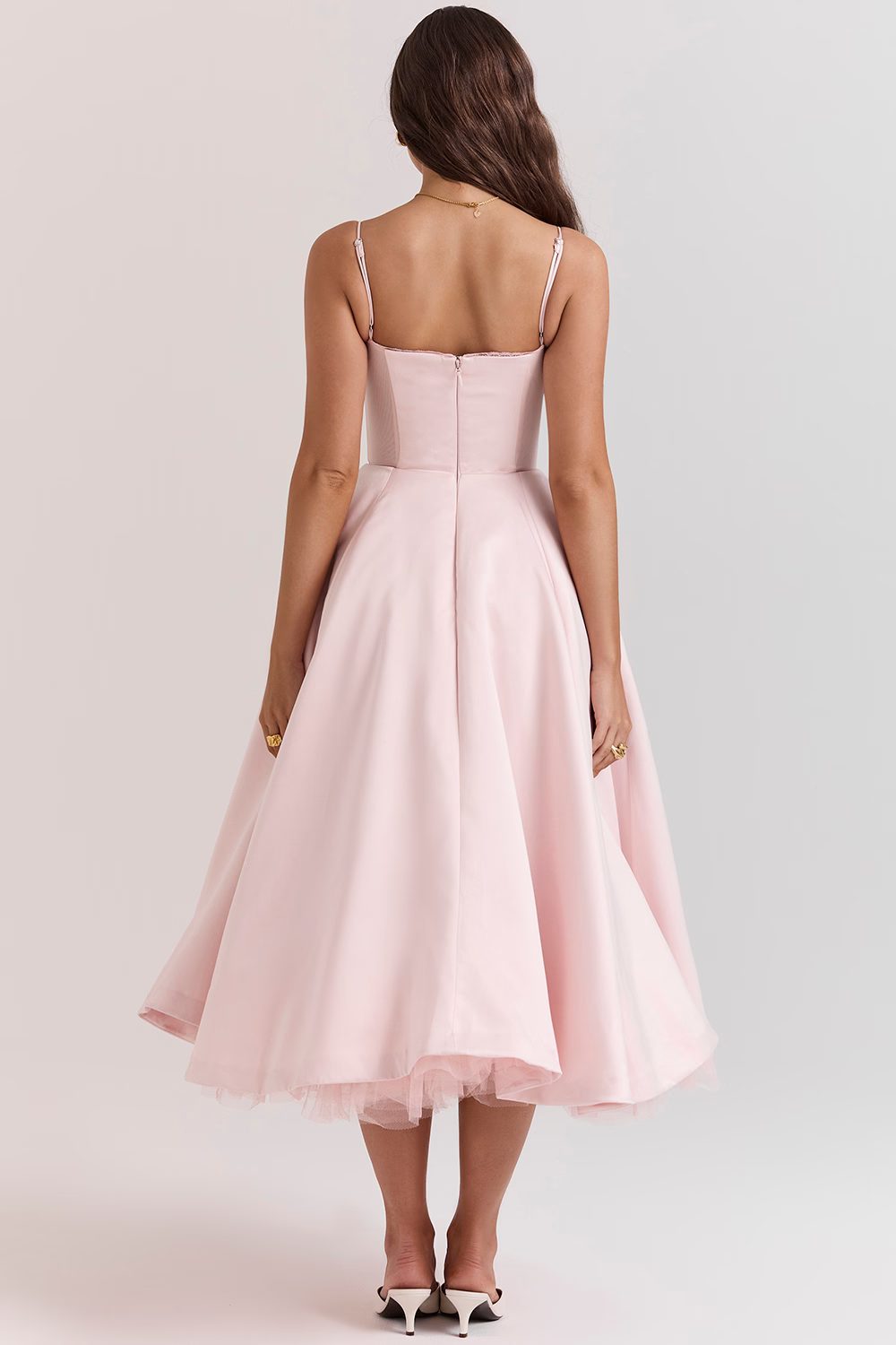 Blush pink back view corset-style dress with spaghetti straps and flared midi skirt