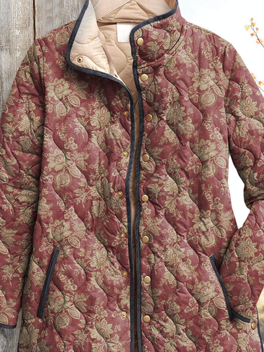 Women's vintage floral jacket close-up, maroon patterned fabric with gold buttons and collar