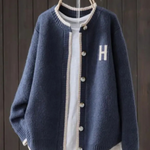Navy classic cardigan with button front, ribbed trim, and 'H' patch