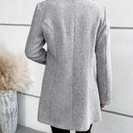 Grey collarless long-sleeve overcoat with herringbone texture, back view