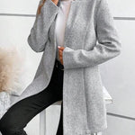 Grey collarless long-sleeve overcoat with structured front and button closure
