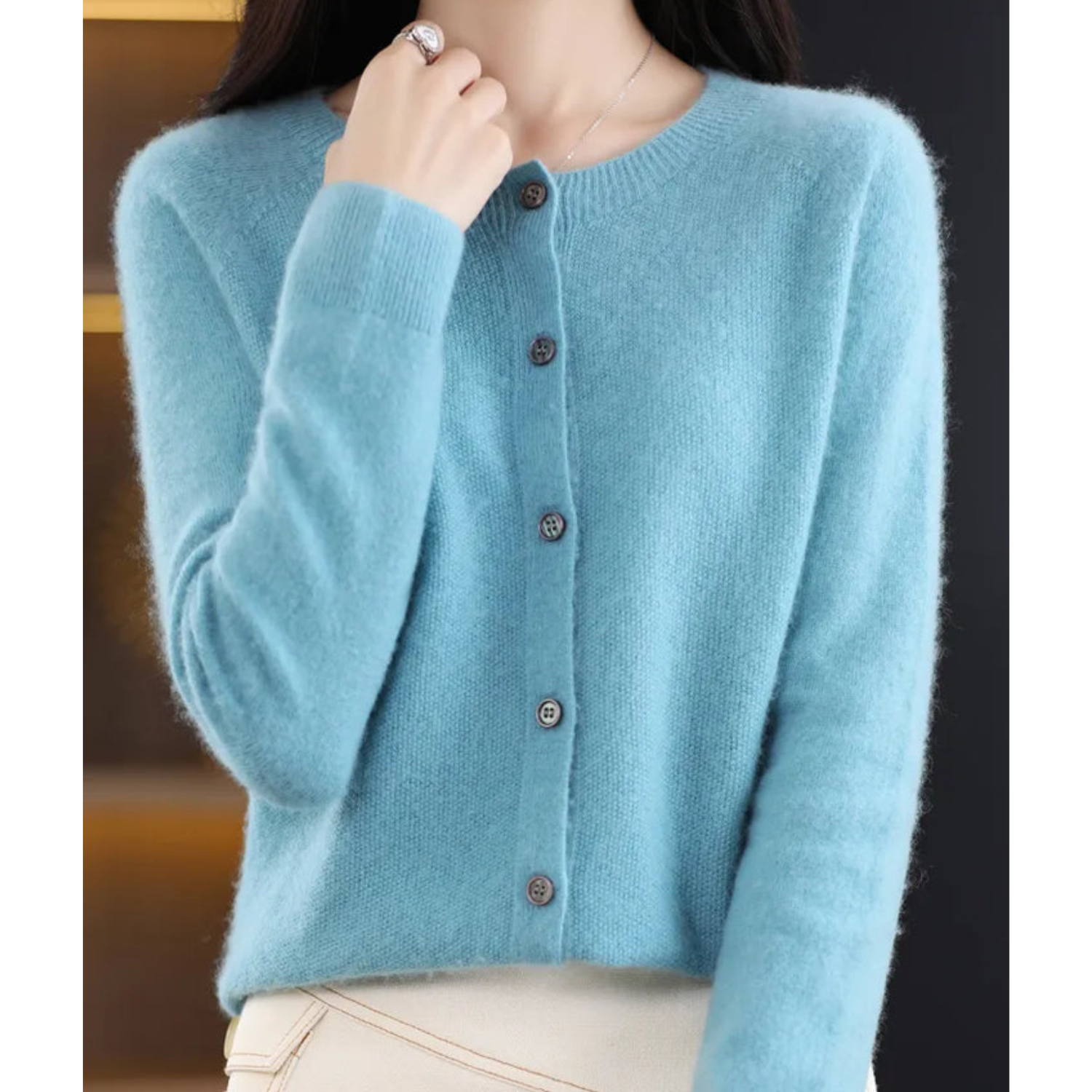 Light blue button-front knit pullover with long sleeves and ribbed cuffs