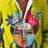 Yellow V-neck cardigan with multicolor face portrait print and white ruffle-trim collar