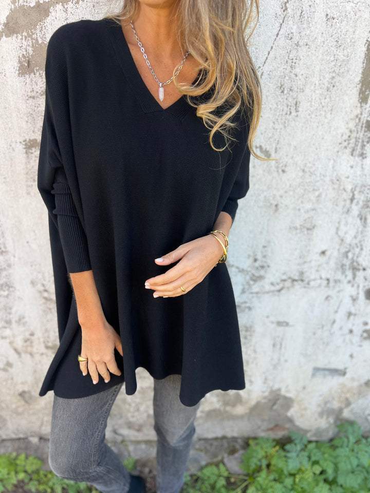 Black V-neck pullover sweater with three-quarter sleeves and relaxed fit.