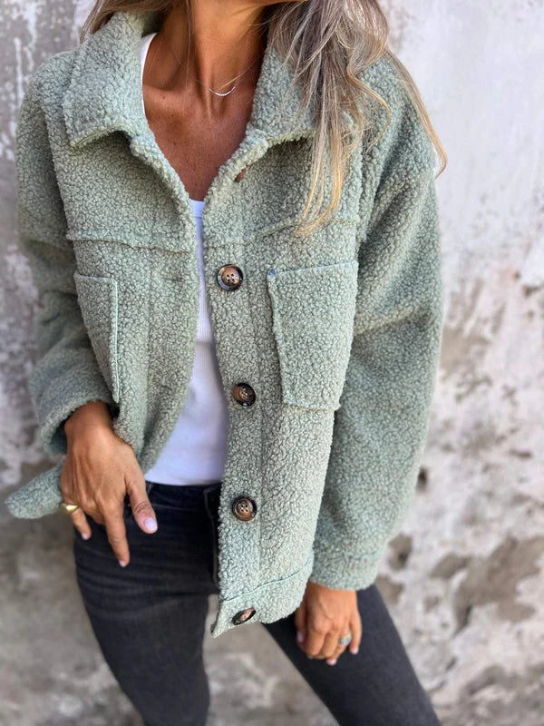 Green short wool jacket with lapels, button front, chest pockets, long sleeves