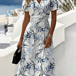 White midi dress with blue leaf print, V-neck, short sleeves, gathered waist